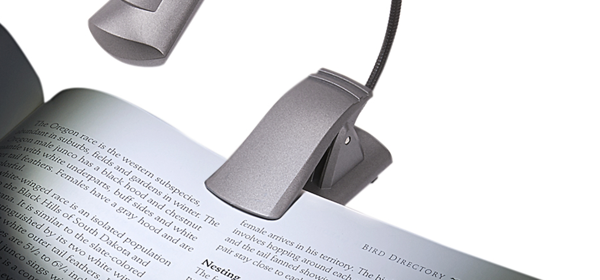 Image of a book illuminated by clip on book light reading aid