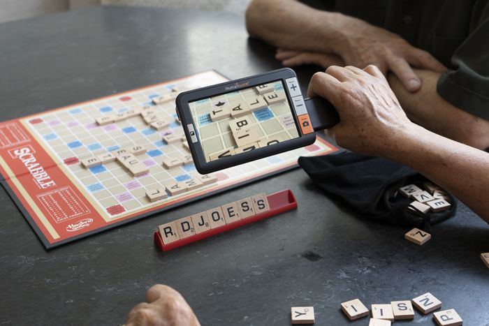 Image of a person using the explore5 while playing Scrabble.