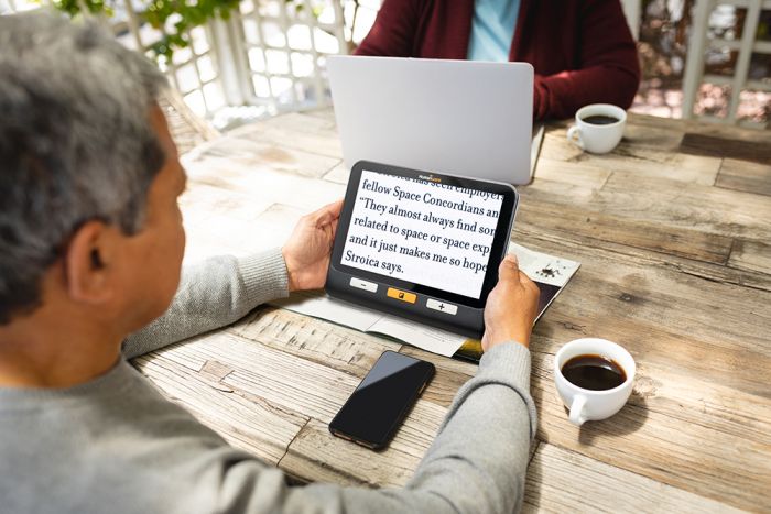 Image of someone reading a magazine using the explorē 8.