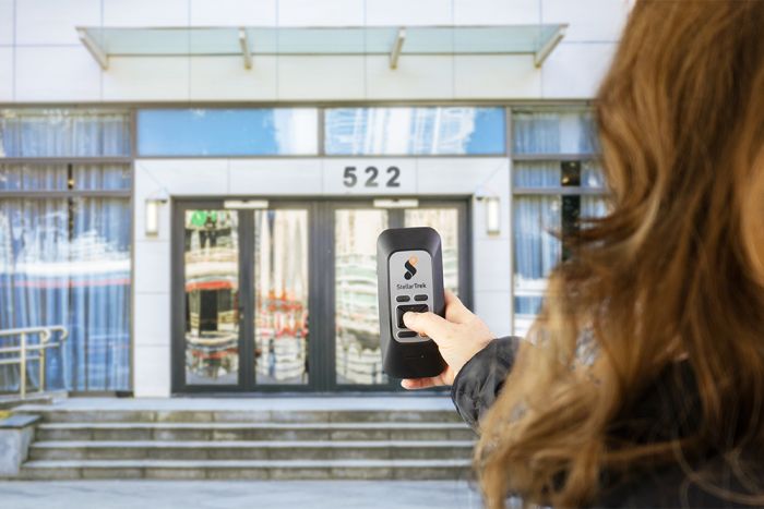 Image of a person standing in front of a building using the StellarTrek – AI-powered GPS Assistant.